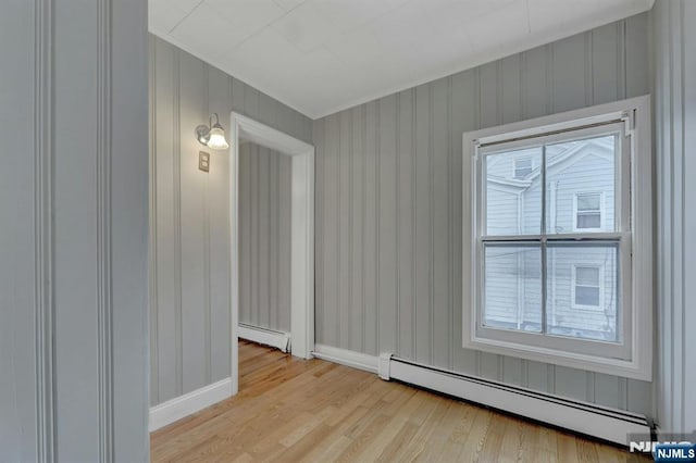 128 Prospect, Midland Park, NJ 07432 - spare room featuring a baseboard heating unit, plenty of natural light, light wood-style flooring, and ornamental molding