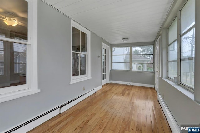 128 Prospect, Midland Park, NJ 07432 - unfurnished sunroom featuring baseboard heating, hardwood / wood-style flooring, and baseboards