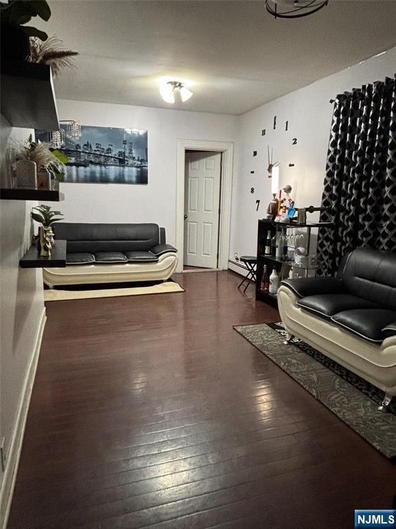 65 Dey St, Paterson, NJ 07503 - living room with hardwood / wood-style floors, baseboards, and a baseboard radiator