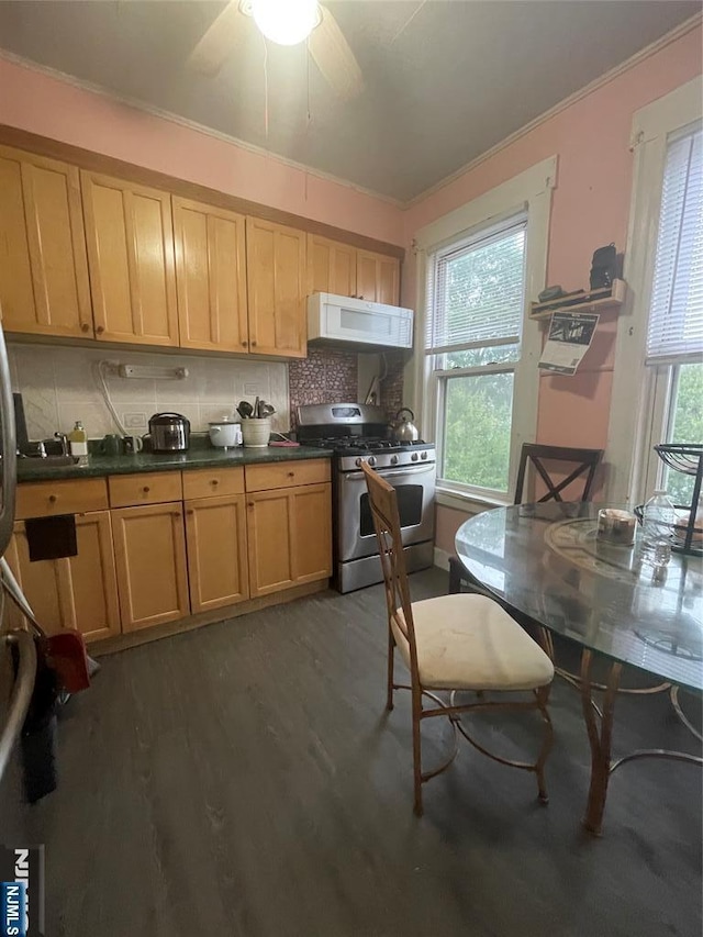 65 Dey St, Paterson, NJ 07503 - kitchen featuring stainless steel gas range, white microwave, wood finished floors, ornamental molding, and decorative backsplash