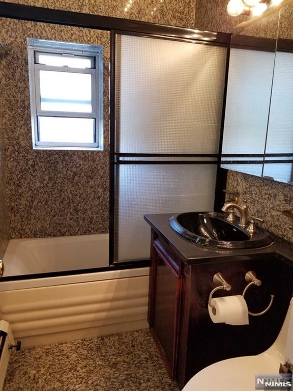 1575 Center Ave Unit 4B, Fort Lee, NJ 07024 - full bath with combined bath / shower with glass door, vanity, and toilet