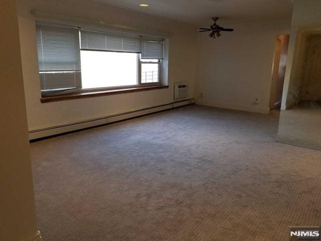 1575 Center Ave Unit 4B, Fort Lee, NJ 07024 - carpeted empty room with baseboard heating, a ceiling fan, a wall unit AC, and baseboards