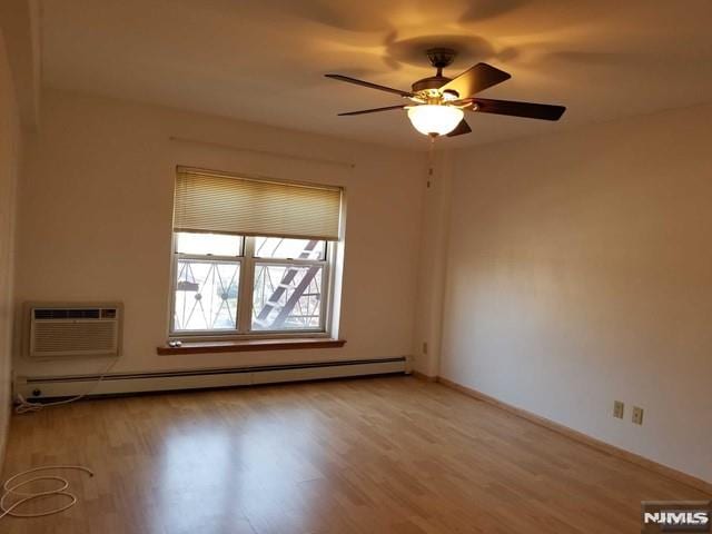 1575 Center Ave Unit 4B, Fort Lee, NJ 07024 - spare room with a baseboard heating unit, light wood-style flooring, a ceiling fan, and baseboards