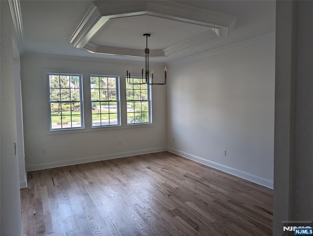 265 Adams Ave, River Edge, NJ 07661 - unfurnished dining area featuring a chandelier, crown molding, a raised ceiling, wood finished floors, and baseboards