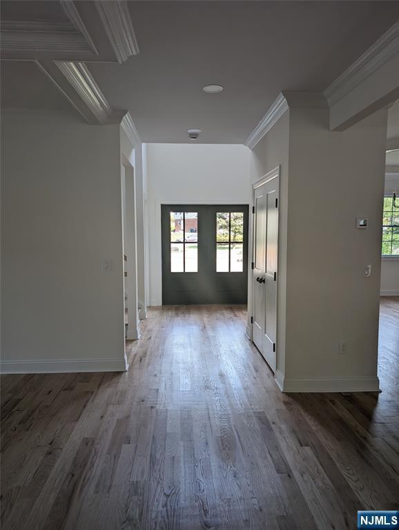 265 Adams Ave, River Edge, NJ 07661 - hallway with wood finished floors, ornamental molding, and baseboards