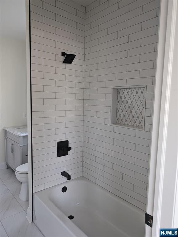 265 Adams Ave, River Edge, NJ 07661 - full bath featuring toilet, tub / shower combination, vanity, and marble look tiles