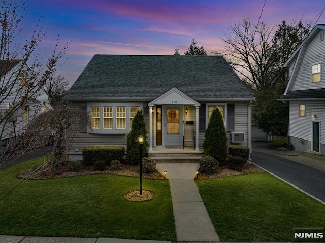 101 Pasadena Pl, Hawthorne, NJ 07506 - view of front of property featuring a shingled roof, a lawn, and cooling unit