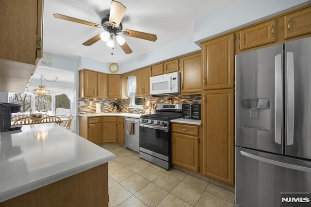 101 Pasadena Pl, Hawthorne, NJ 07506 - kitchen with stainless steel appliances, light countertops, decorative backsplash, and ceiling fan