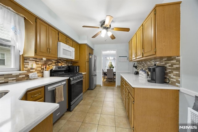 101 Pasadena Pl, Hawthorne, NJ 07506 - kitchen featuring stainless steel appliances, a ceiling fan, backsplash, and light countertops