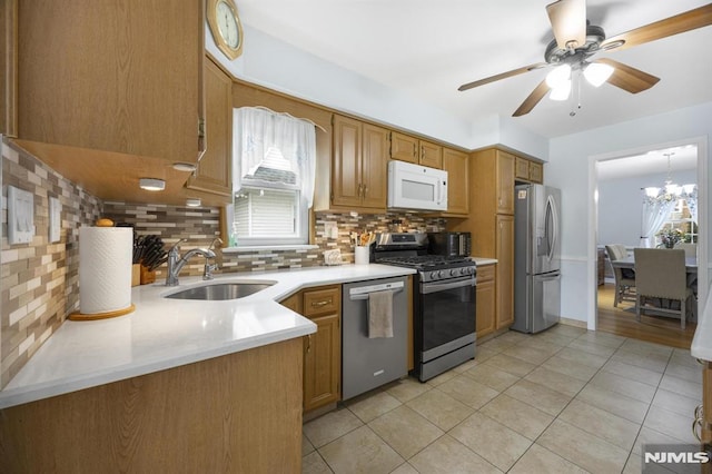 101 Pasadena Pl, Hawthorne, NJ 07506 - kitchen featuring appliances with stainless steel finishes, a sink, tasteful backsplash, light tile patterned flooring, and healthy amount of natural light