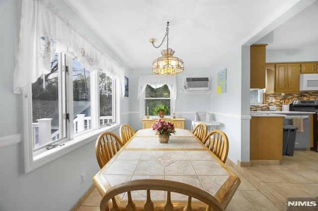 101 Pasadena Pl, Hawthorne, NJ 07506 - dining area with a wall unit AC, a chandelier, and baseboards