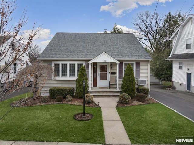 101 Pasadena Pl, Hawthorne, NJ 07506 - view of front of home featuring a shingled roof, a front yard, and cooling unit