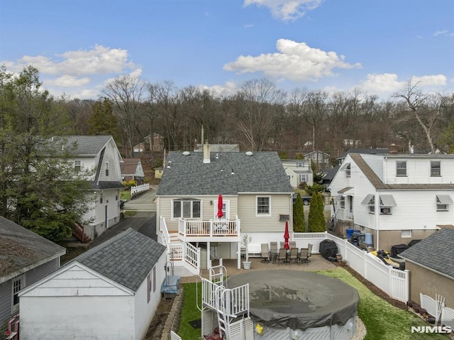 101 Pasadena Pl, Hawthorne, NJ 07506 - rear view of house featuring a fenced backyard, a deck, a residential view, and a shingled roof