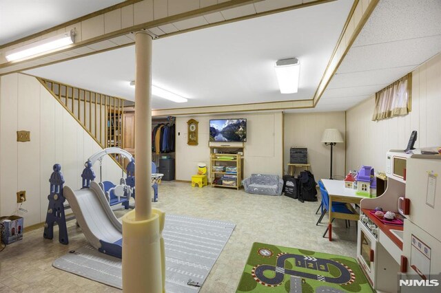 101 Pasadena Pl, Hawthorne, NJ 07506 - recreation room featuring tile patterned floors and a decorative wall