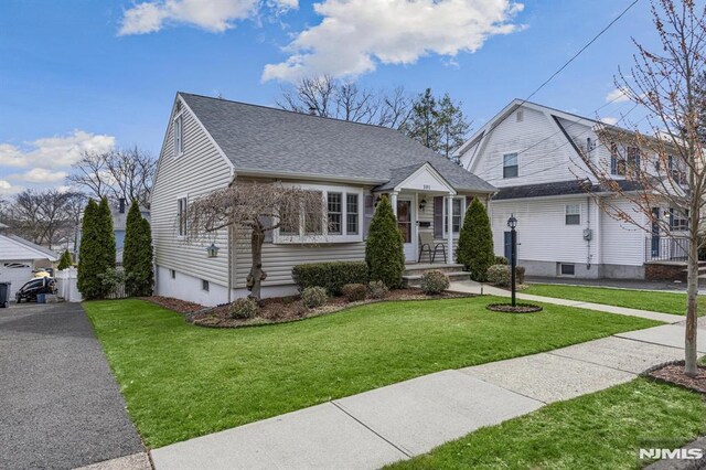 101 Pasadena Pl, Hawthorne, NJ 07506 - view of front of home featuring roof with shingles and a front yard