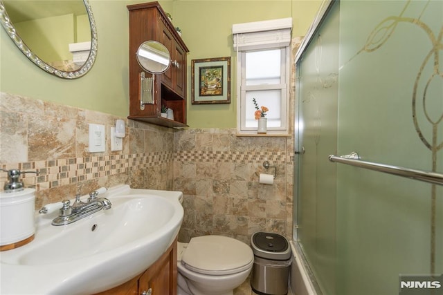4310 Newkirk Ave, North Bergen, NJ 07047 - bathroom with toilet, tile walls, vanity, and a wainscoted wall