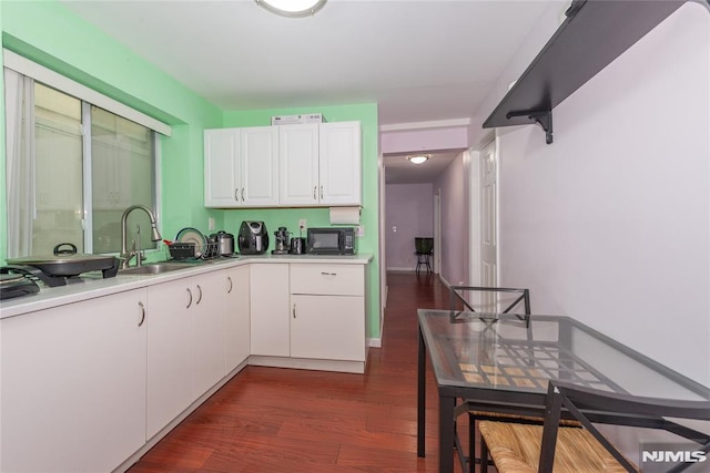 4310 Newkirk Ave, North Bergen, NJ 07047 - kitchen featuring black microwave, a sink, dark wood finished floors, white cabinetry, and light countertops