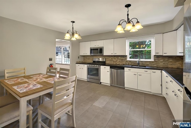 114 Summit Cross, Rutherford, NJ 07070 - kitchen with stainless steel appliances, a chandelier, plenty of natural light, and decorative backsplash