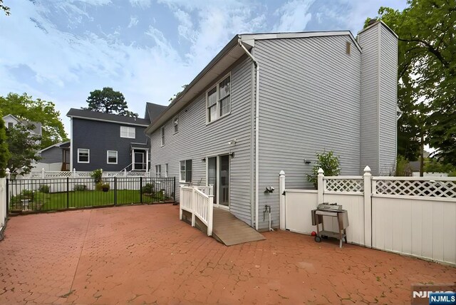 114 Summit Cross, Rutherford, NJ 07070 - back of house with a patio area and a chimney