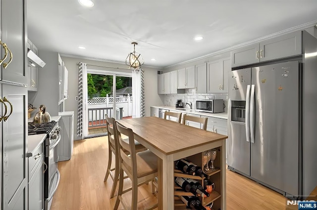 114 Summit Cross, Rutherford, NJ 07070 - kitchen with appliances with stainless steel finishes, light countertops, light wood-style floors, tasteful backsplash, and recessed lighting