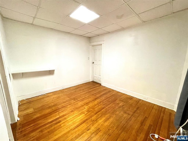 208 Wayne Ave, Cliffside Park, NJ 07010 - unfurnished room with a drop ceiling, baseboards, and wood-type flooring