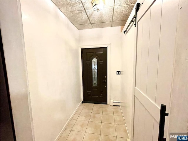 208 Wayne Ave, Cliffside Park, NJ 07010 - doorway featuring light tile patterned flooring, a baseboard radiator, a barn door, and baseboards