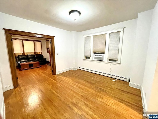 208 Wayne Ave, Cliffside Park, NJ 07010 - empty room featuring baseboard heating, light wood-style floors, baseboards, and cooling unit