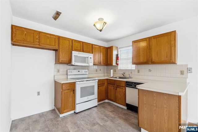 239 40th St Unit C0007, Irvington, NJ 07111 - kitchen with white appliances, a sink, backsplash, and brown cabinets