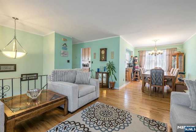 21 Liberty St, Dover Town, NJ 07801 - living area featuring a chandelier, wood finished floors, ornamental molding, and baseboards