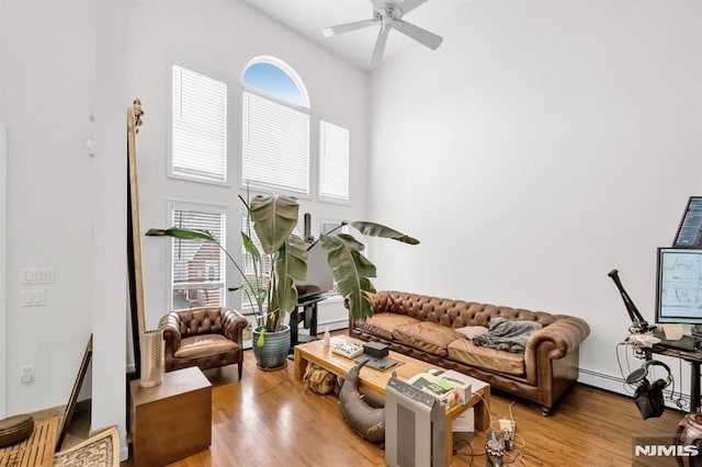 755 Jefferson Ave, Cliffside Park, NJ 07010 - living room with wood finished floors, a ceiling fan, and a high ceiling