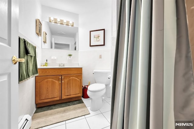 755 Jefferson Ave, Cliffside Park, NJ 07010 - bathroom featuring tile walls, baseboard heating, tile patterned flooring, vanity, and toilet
