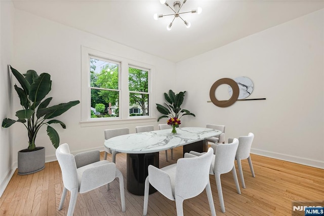 41 Oakland Ave, Westwood, NJ 07675 - dining space with a chandelier, baseboards, and light wood finished floors