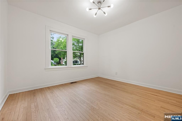 41 Oakland Ave, Westwood, NJ 07675 - spare room featuring a chandelier, light wood-style floors, and baseboards