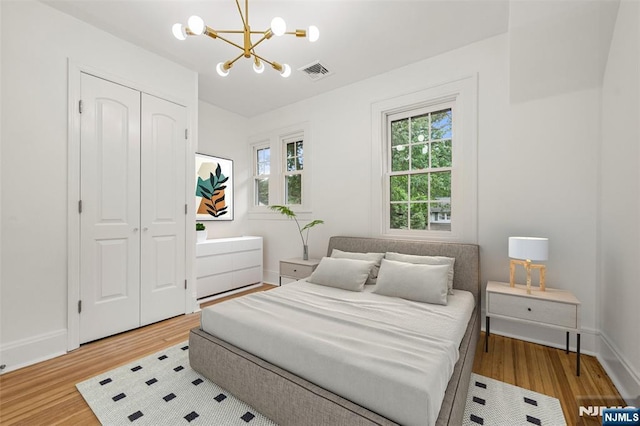 41 Oakland Ave, Westwood, NJ 07675 - bedroom featuring a chandelier, wood finished floors, a closet, and baseboards