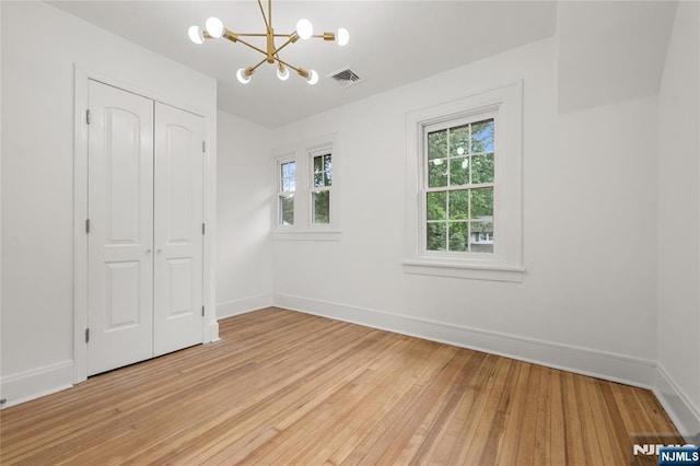 41 Oakland Ave, Westwood, NJ 07675 - unfurnished bedroom featuring a chandelier, light wood-style flooring, a closet, and baseboards