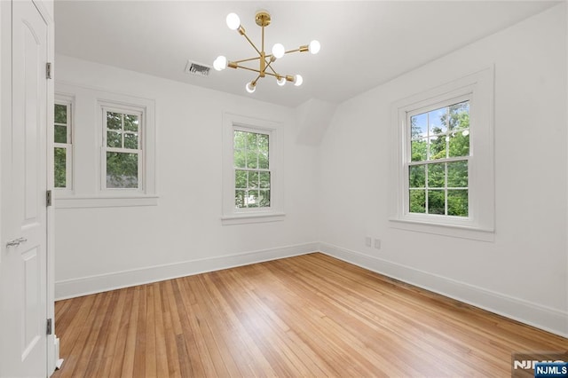 41 Oakland Ave, Westwood, NJ 07675 - empty room with a chandelier, baseboards, and light wood-style flooring
