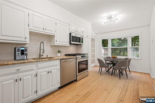 41 Oakland Ave, Westwood, NJ 07675 - kitchen featuring a sink, appliances with stainless steel finishes, tasteful backsplash, white cabinets, and baseboards