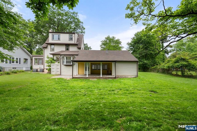 41 Oakland Ave, Westwood, NJ 07675 - back of house featuring a yard, a patio area, and roof with shingles