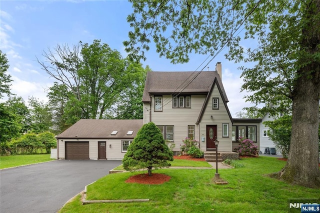 41 Oakland Ave, Westwood, NJ 07675 - view of front facade with driveway, a chimney, a garage, and a front lawn