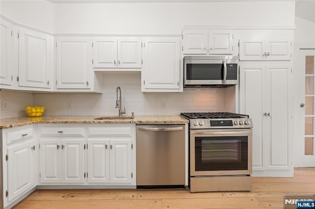 41 Oakland Ave, Westwood, NJ 07675 - kitchen featuring appliances with stainless steel finishes, a sink, and white cabinets