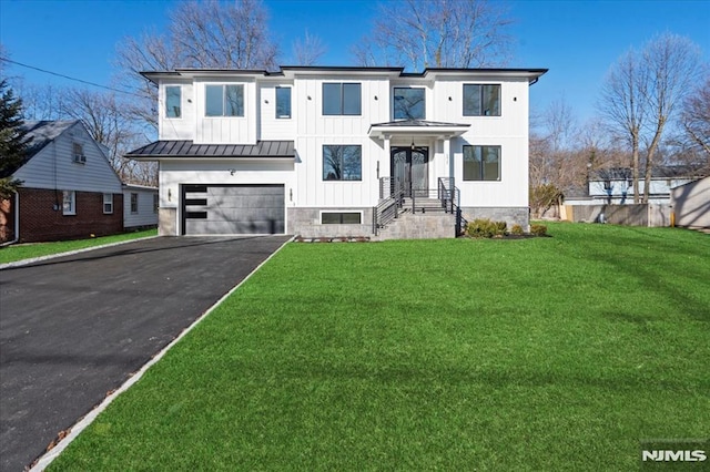 171 Brookfield Ave, Paramus, NJ 07652 - view of front of house with driveway, a standing seam roof, a garage, a front yard, and metal roof