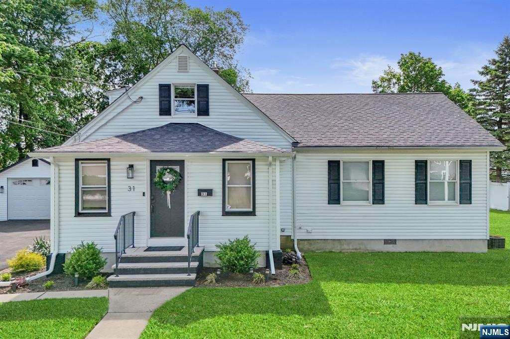 31 Andrews Pl, Pequannock Township, NJ 07444 - bungalow-style home featuring an outdoor structure, a shingled roof, a front lawn, and driveway