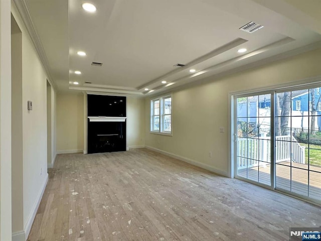178 Leonard Pl, North Arlington, NJ 07031 - unfurnished living room with wood finished floors, recessed lighting, a tray ceiling, and a fireplace