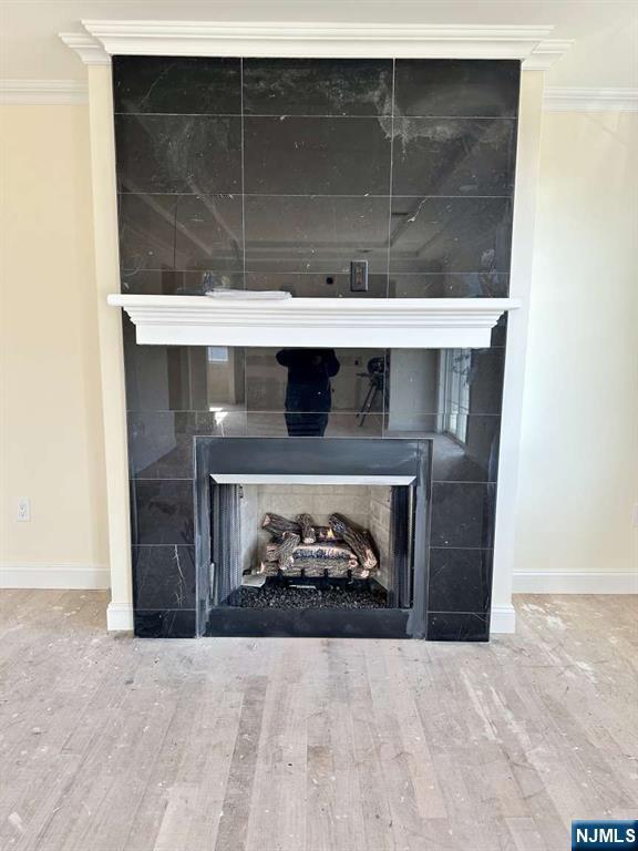 178 Leonard Pl, North Arlington, NJ 07031 - detailed view of a tiled fireplace, wood finished floors, and ornamental molding