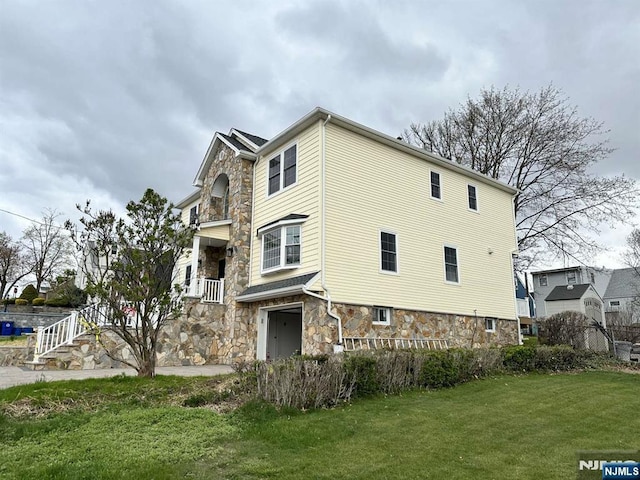 178 Leonard Pl, North Arlington, NJ 07031 - view of property exterior featuring stone siding and a lawn