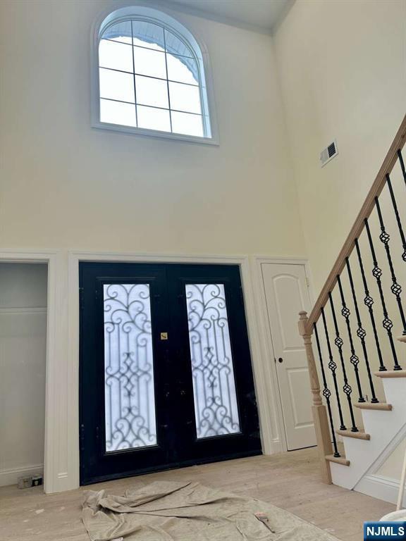 178 Leonard Pl, North Arlington, NJ 07031 - foyer with a high ceiling, french doors, and stairs