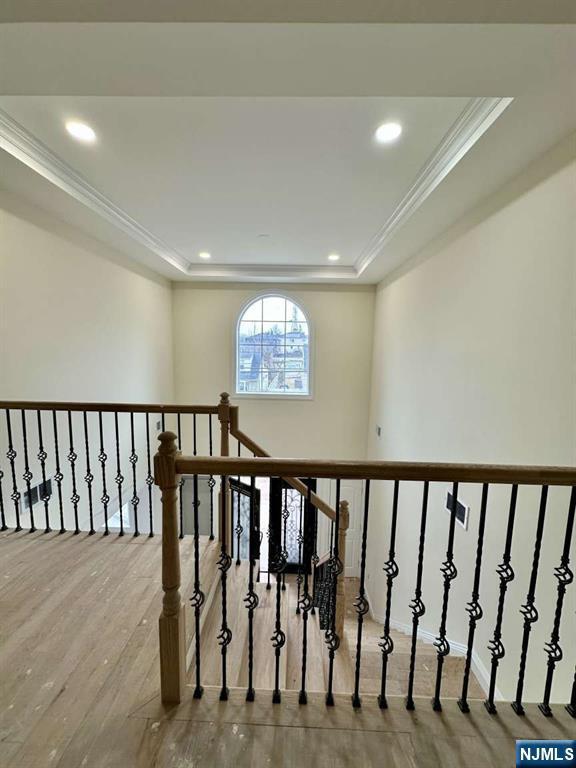 178 Leonard Pl, North Arlington, NJ 07031 - stairs with wood finished floors, crown molding, a raised ceiling, and recessed lighting