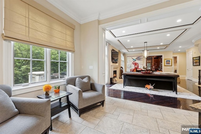 511 Bellaire Dr, Demarest, NJ 07627 - living area with a lit fireplace, ornamental molding, recessed lighting, stone tile floors, and baseboards