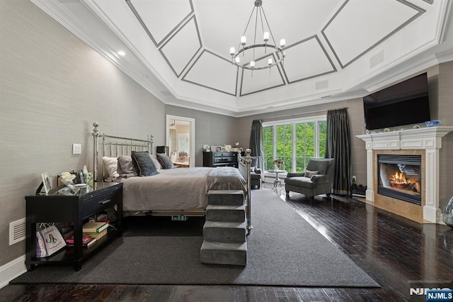 511 Bellaire Dr, Demarest, NJ 07627 - bedroom featuring wood finished floors, a tile fireplace, a chandelier, ornamental molding, and baseboards