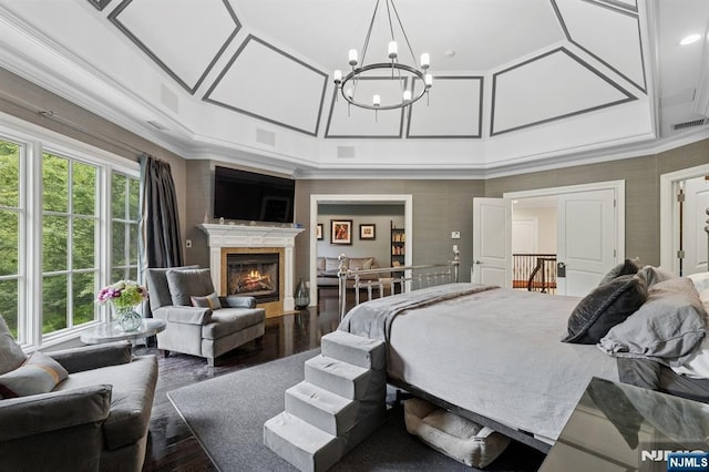 511 Bellaire Dr, Demarest, NJ 07627 - bedroom featuring a chandelier, a fireplace with flush hearth, ornamental molding, and wood finished floors